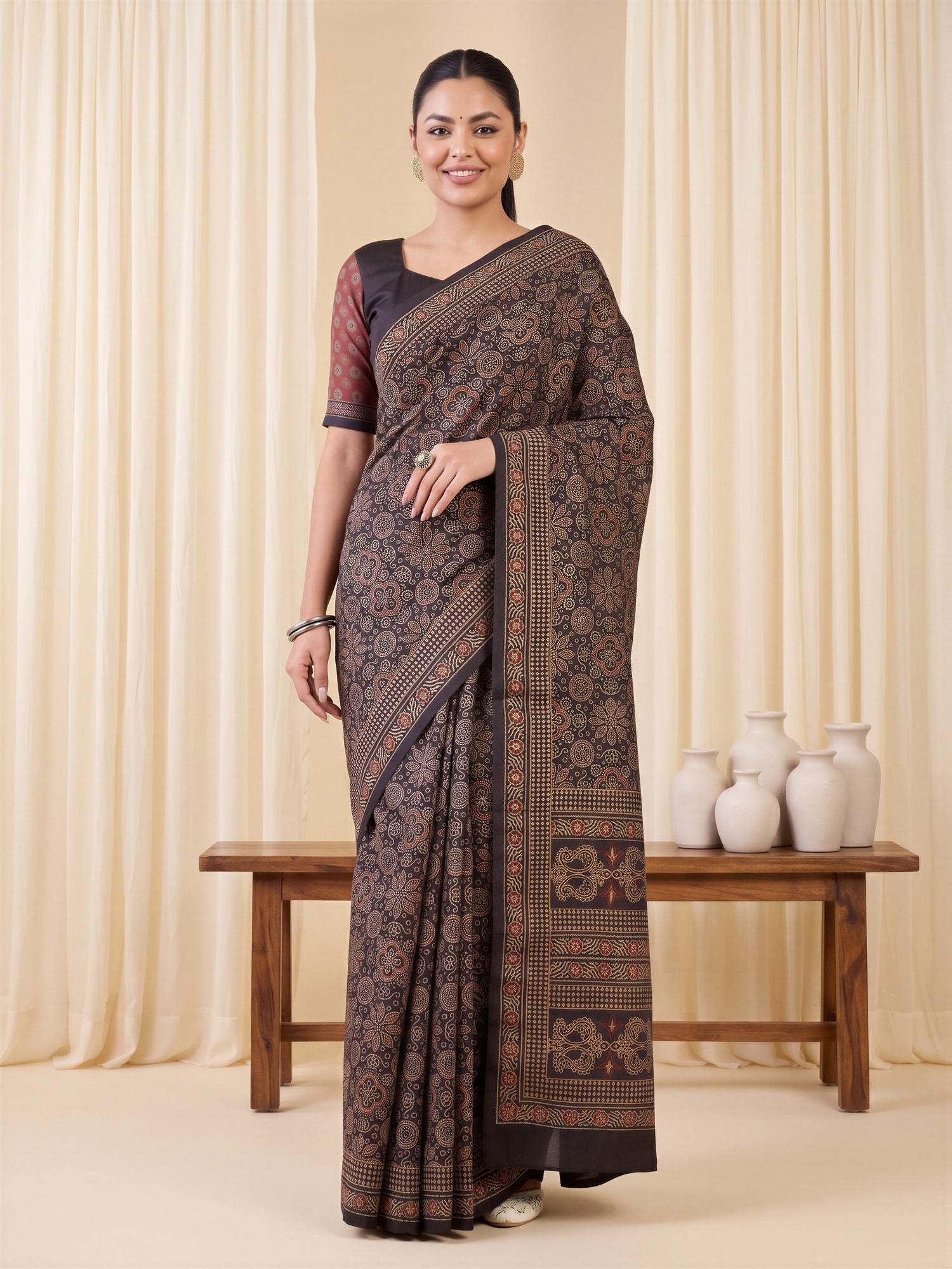 Woman wearing coffee brown silk blend saree with ajrak block-print motif work and coffee brown blouse