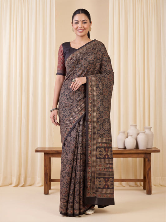 Woman wearing coffee brown silk blend saree with ajrak block-print motif work and coffee brown blouse