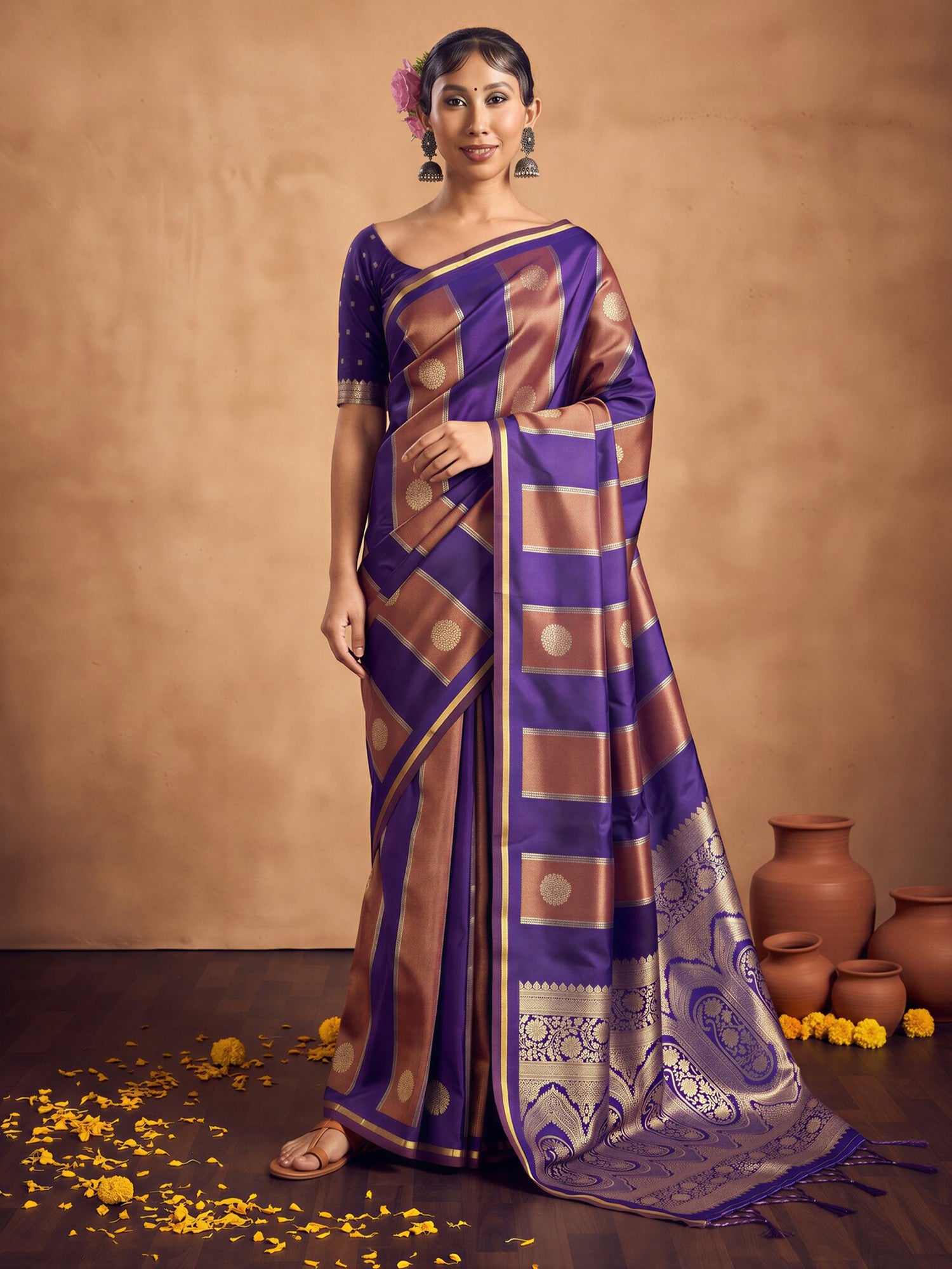 Woman wearing purple satin saree with traditional indian motif work and purple blouse
