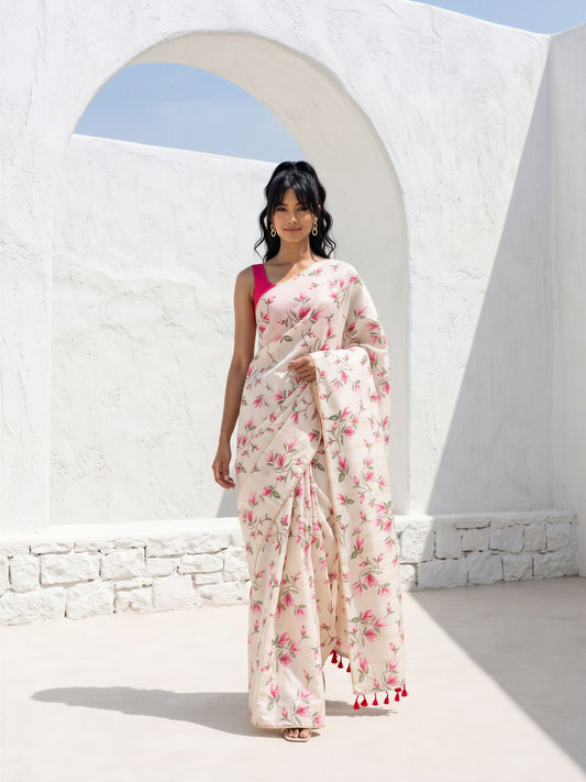Woman wearing off white cotton blend saree with all-over floral design and pink blouse