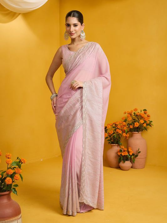 Woman wearing pink pure georgette saree with embroidered motif work and pink blouse