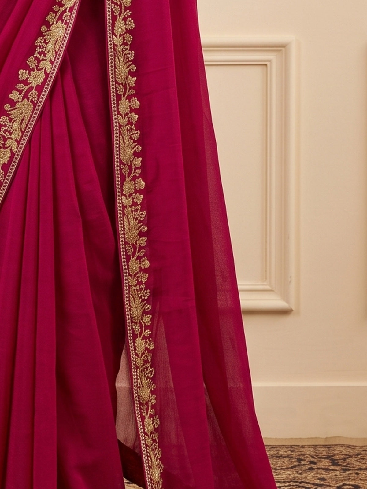Pallu detail of pink vichitra silk saree showing ornamented surface design and embellished border