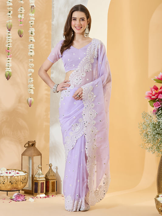 Woman wearing lavender organza saree with embroidered motif work and lavender blouse
