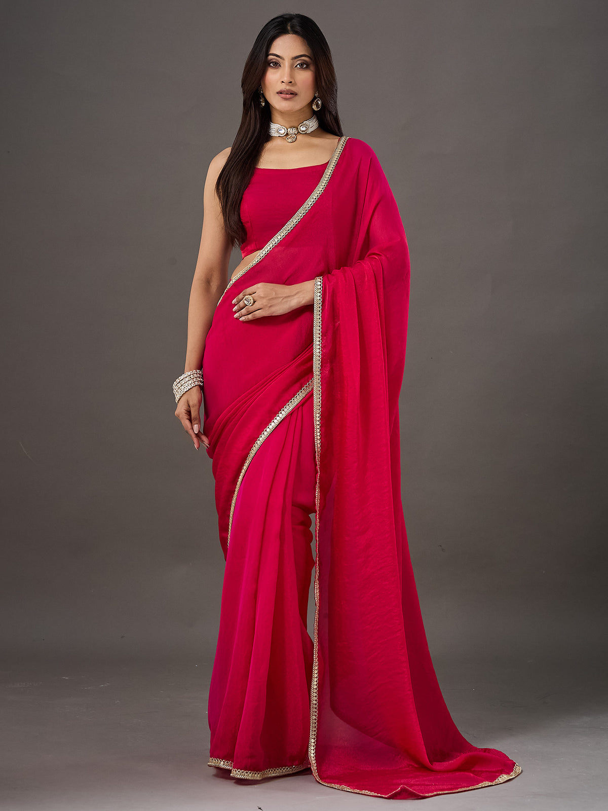 Woman wearing pink georgette saree with clean solid-tone finish and pink blouse