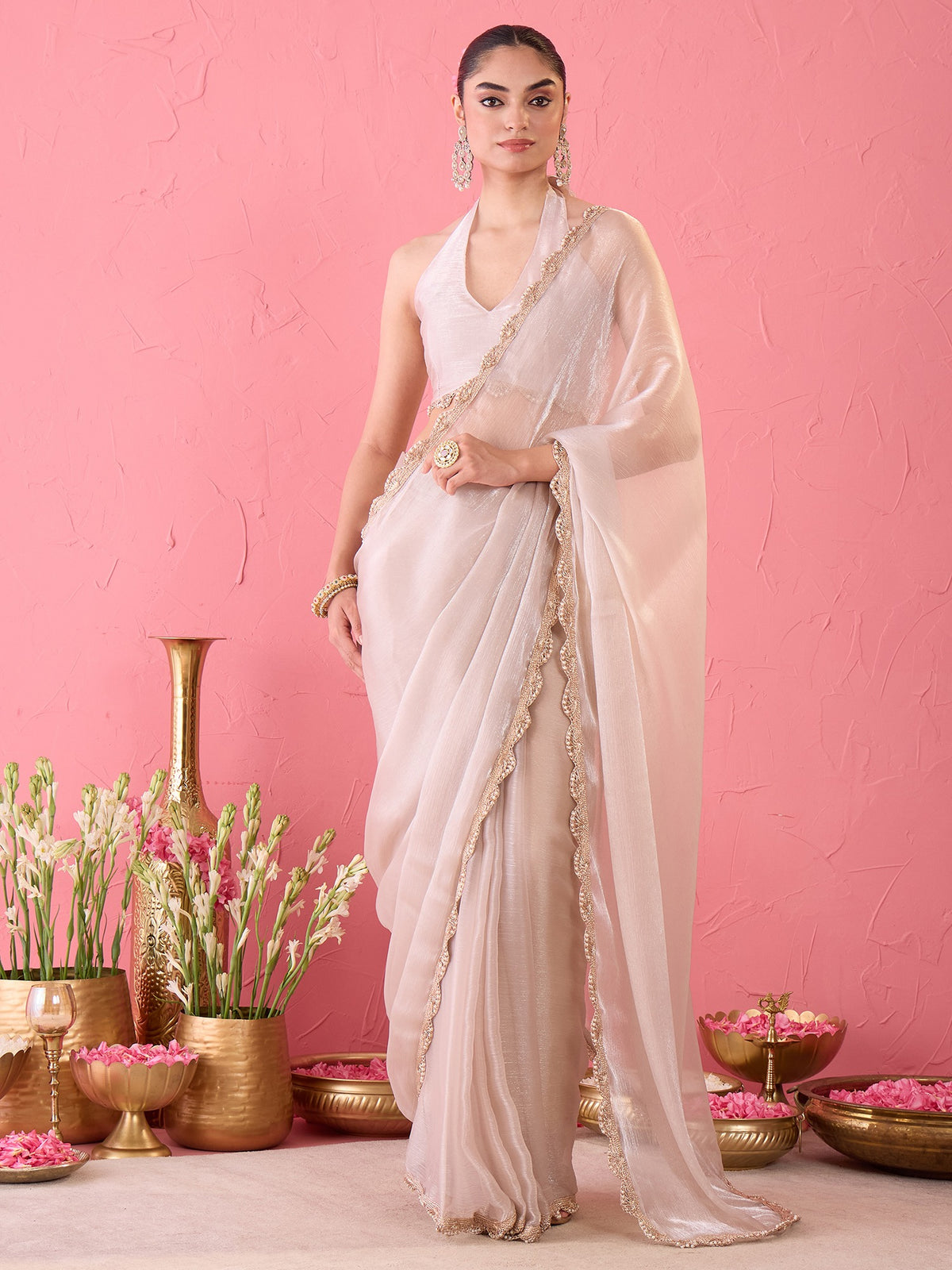 Woman wearing cream organza ready to wear saree with clean solid-tone finish and cream blouse