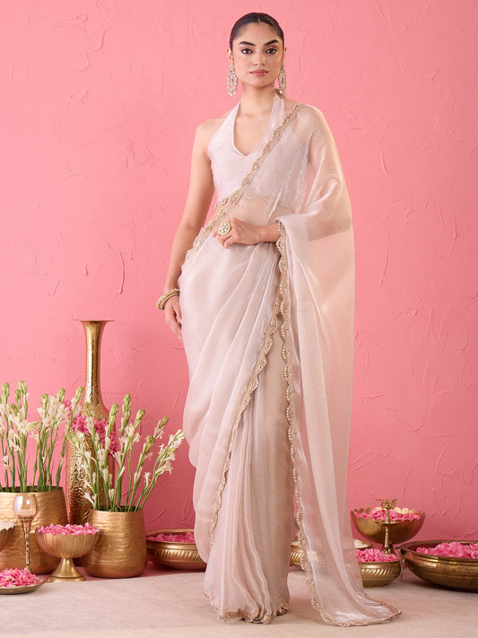 Woman wearing cream organza ready to wear saree with clean solid-tone finish and cream blouse