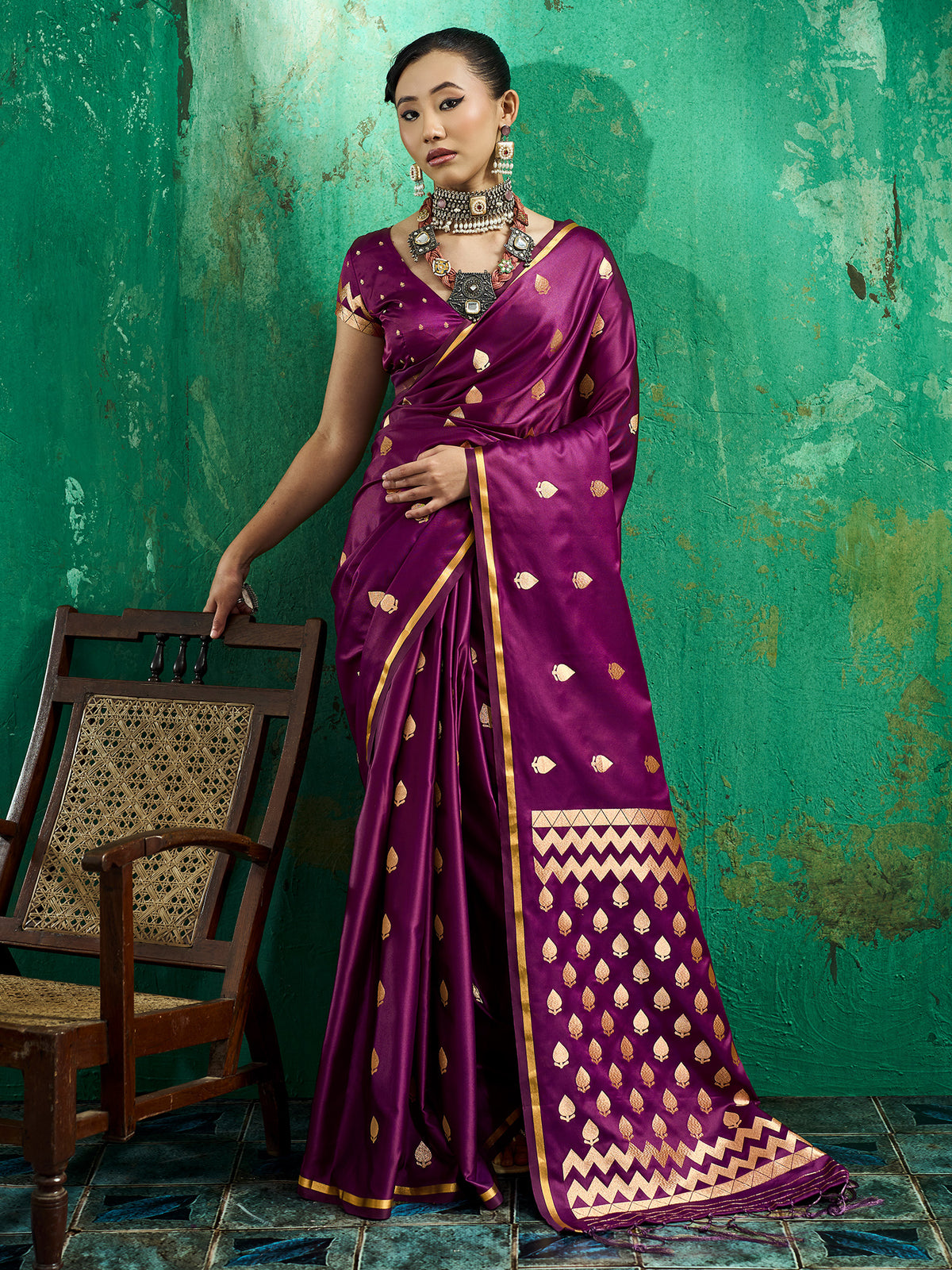 Woman wearing wine satin silk saree with zari butta (metallic motif) work and wine blouse