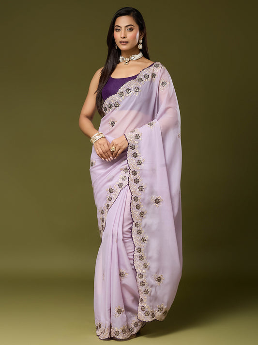 Woman wearing lavender georgette saree with embroidered motif work and purple blouse
