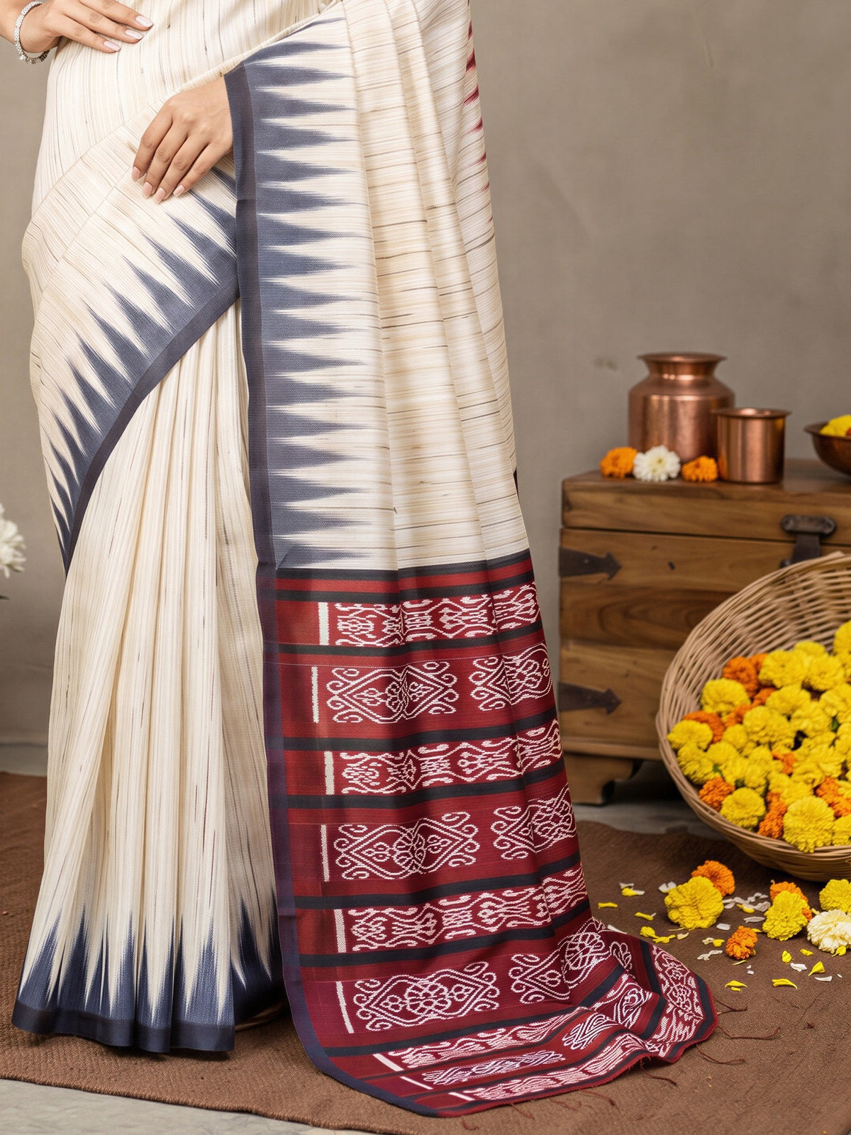 Pallu detail of beige bhagalpuri silk saree showing ikat resist-dyed pattern and printed border