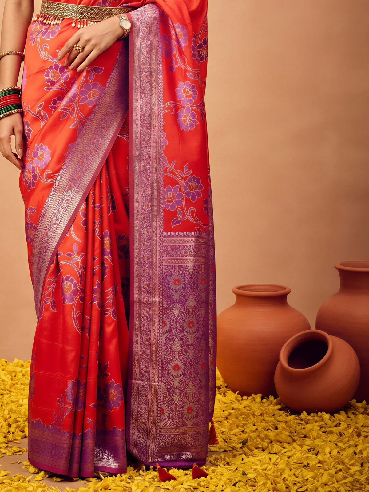 Pallu detail of red satin silk saree showing botanical floral and leaf design and zari border