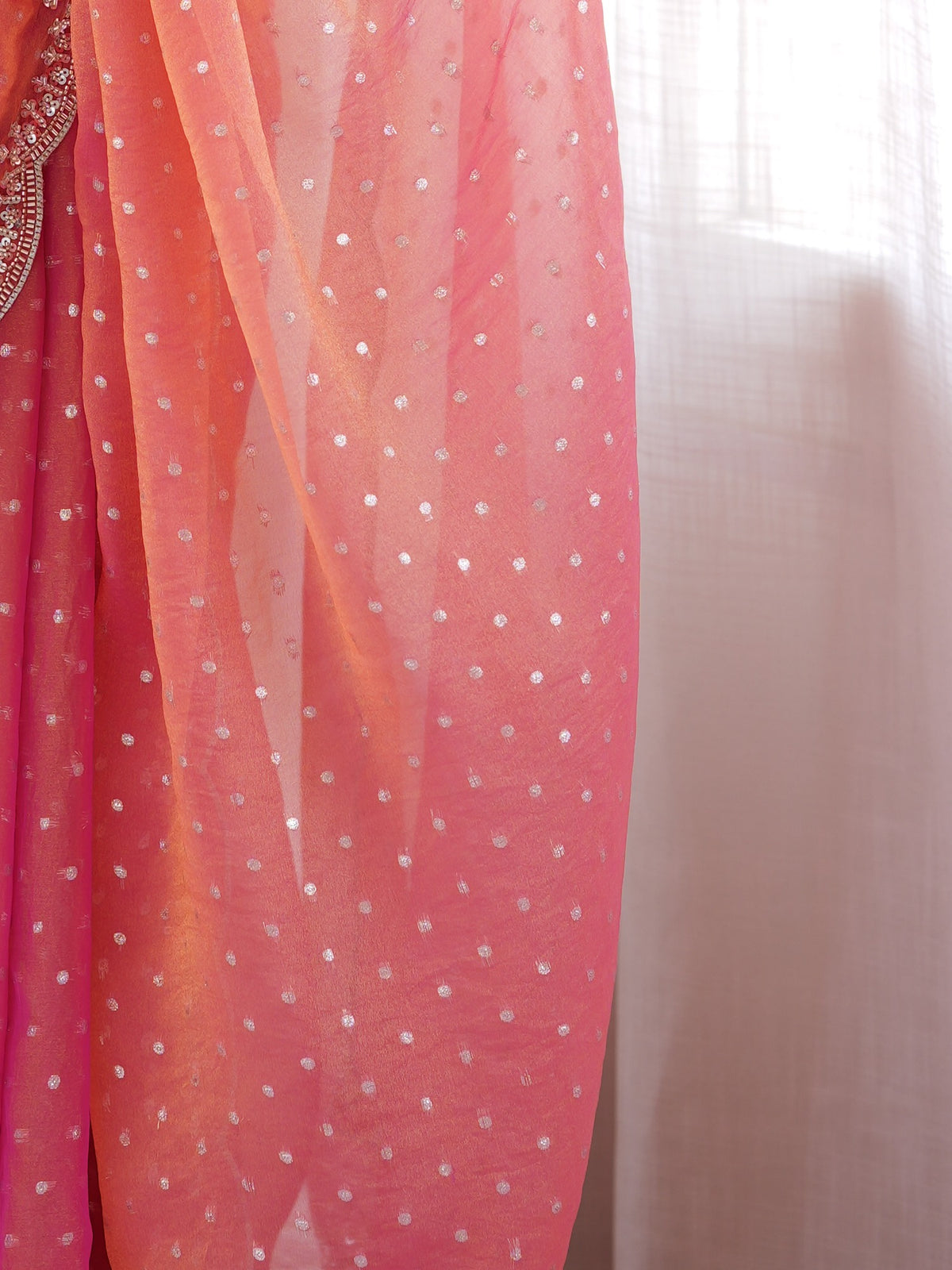 Pallu detail of pink silk blend saree showing ornamented surface design and scallop border