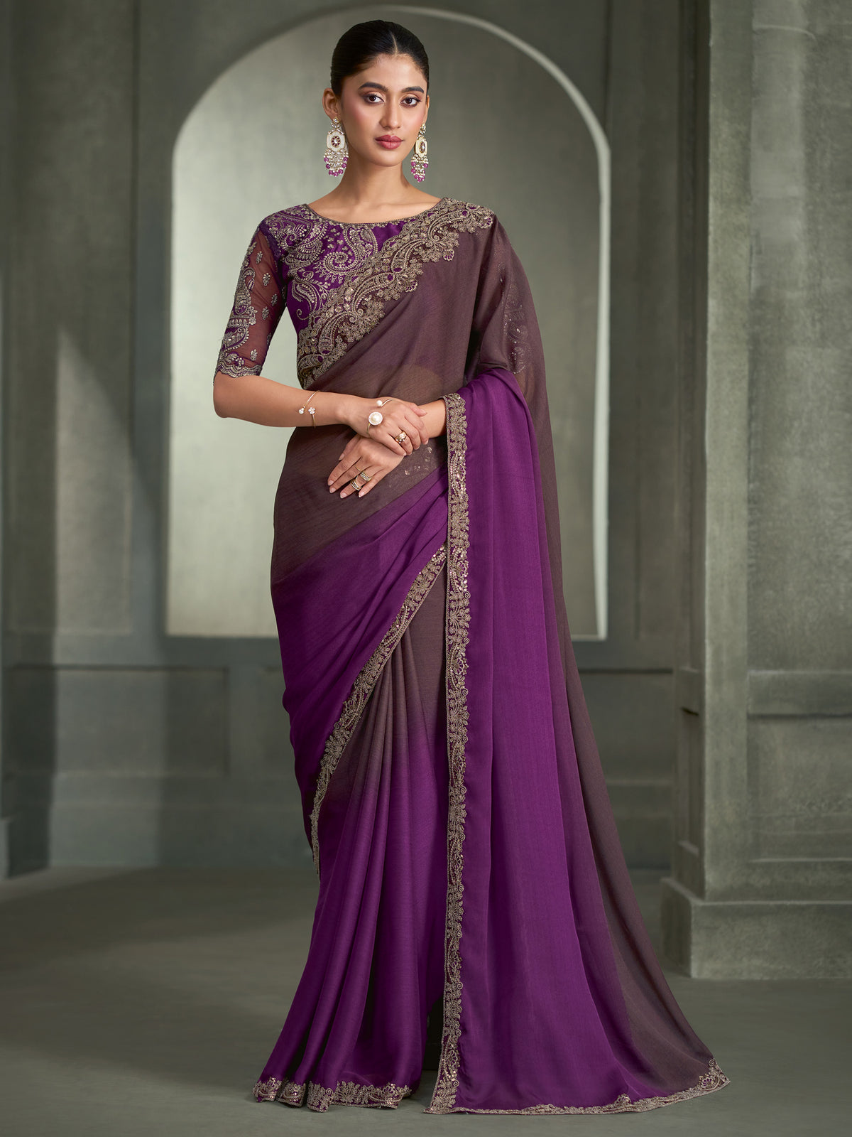 Woman wearing purple chiffon saree with ombre graded colour work and purple blouse
