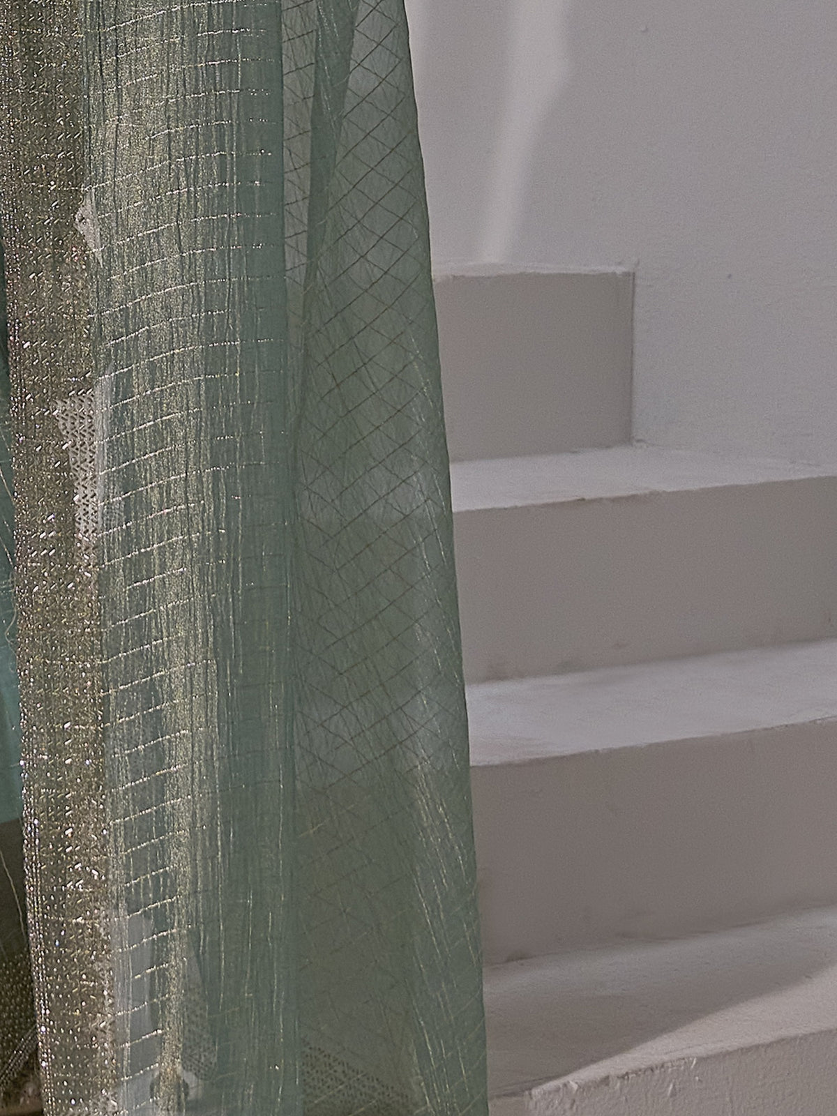 Pallu detail of light blue organza saree showing striped pattern design and embellished border