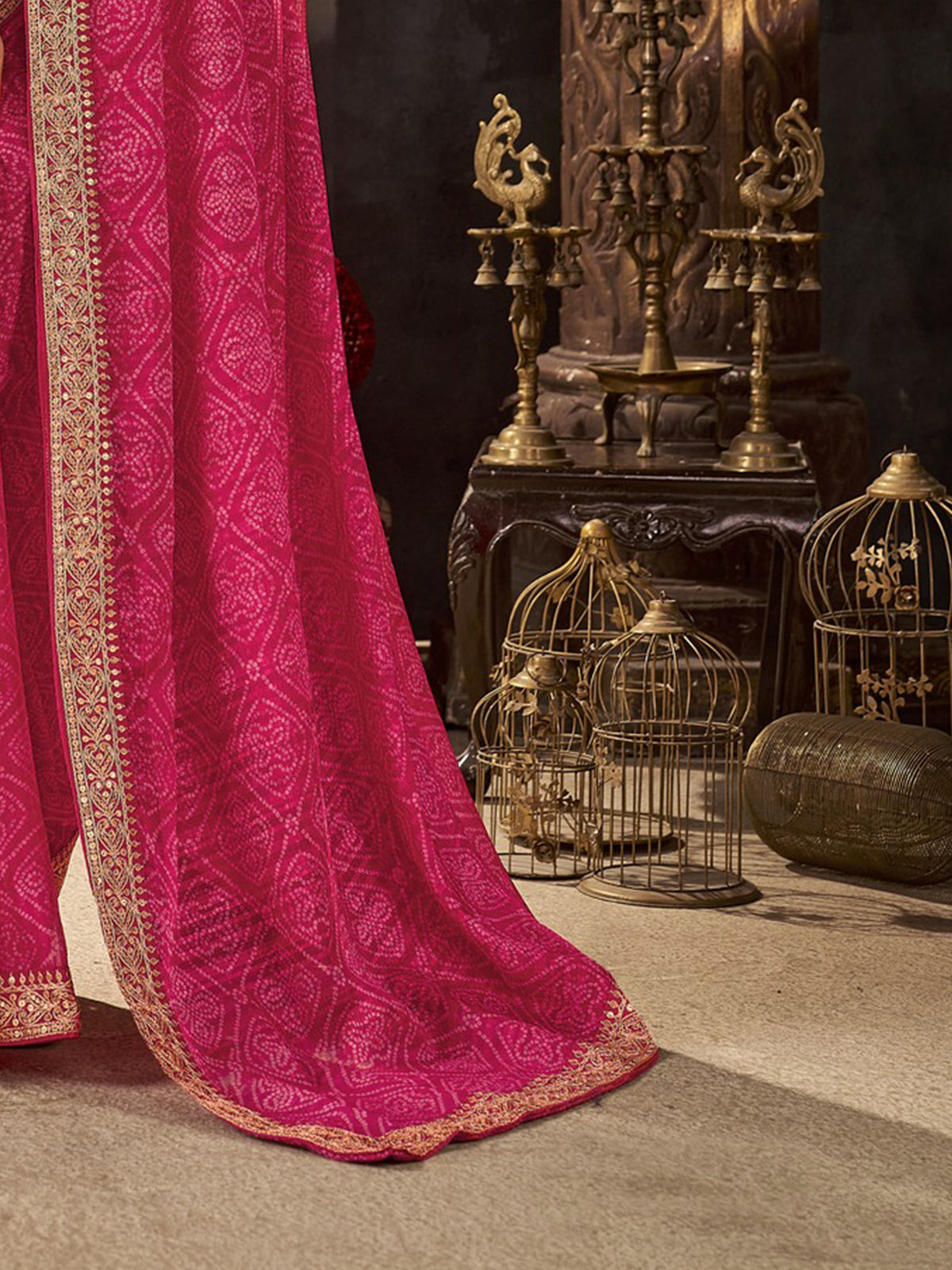 Pallu detail of pink chiffon saree showing bandhani tie-dye dot work and embellished border