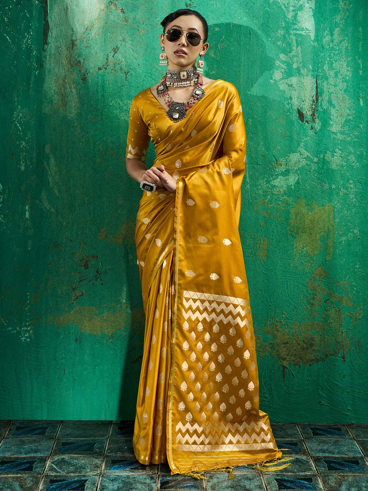 Woman wearing yellow satin silk saree with zari butta (metallic motif) work and yellow blouse