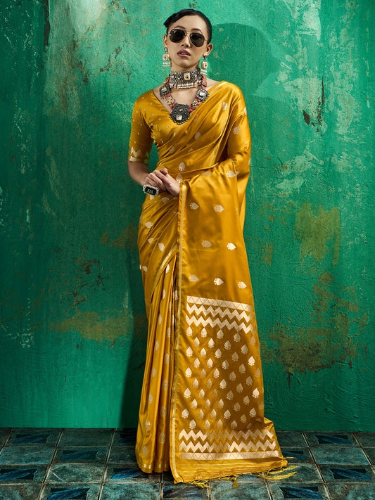 Woman wearing yellow satin silk saree with zari butta (metallic motif) work and yellow blouse