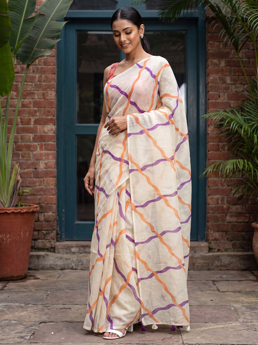 Woman wearing cream cotton linen saree with geometric pattern design and peach blouse
