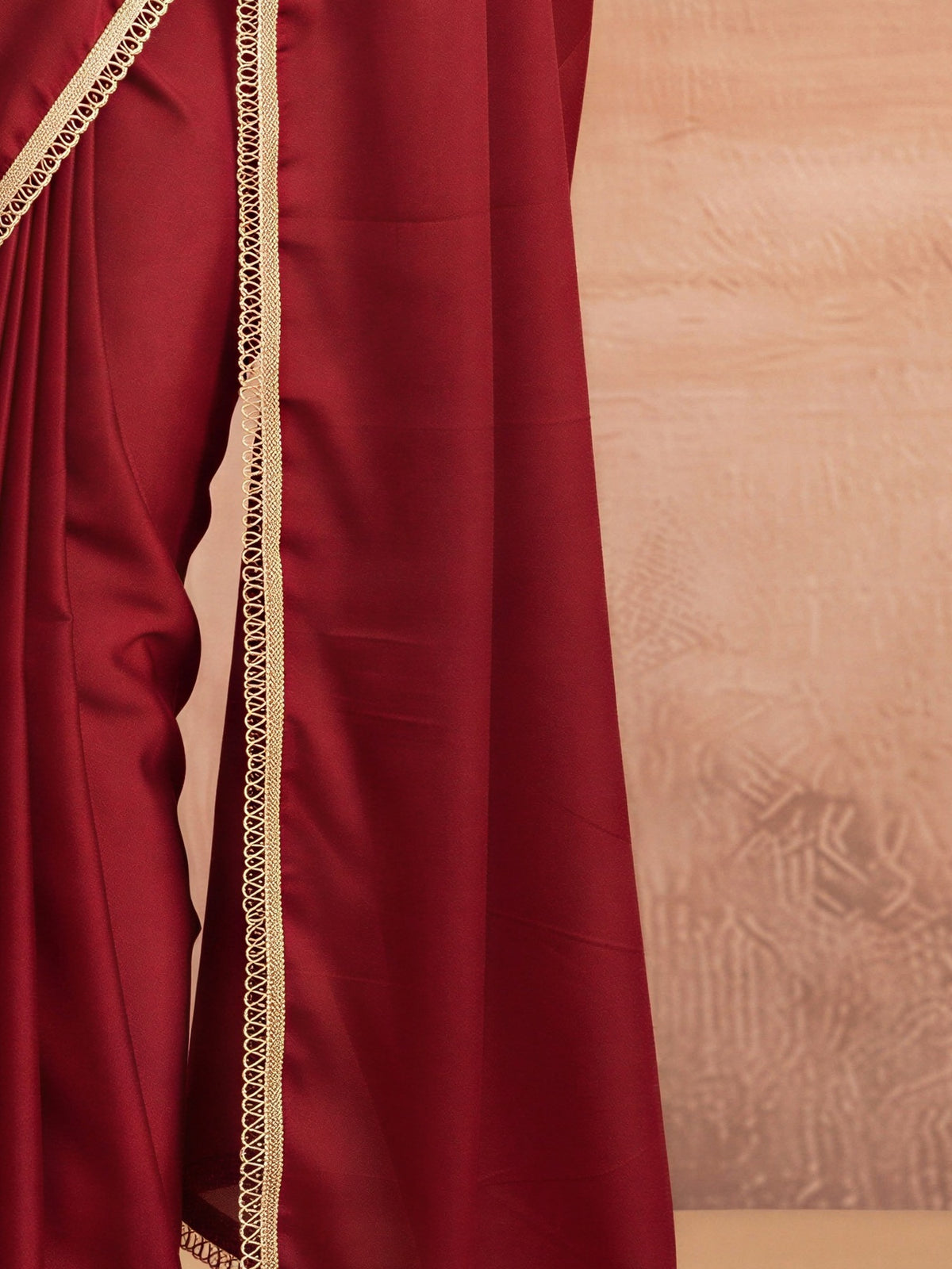 Pallu detail of maroon satin silk saree showing clean solid-tone finish and embellished border