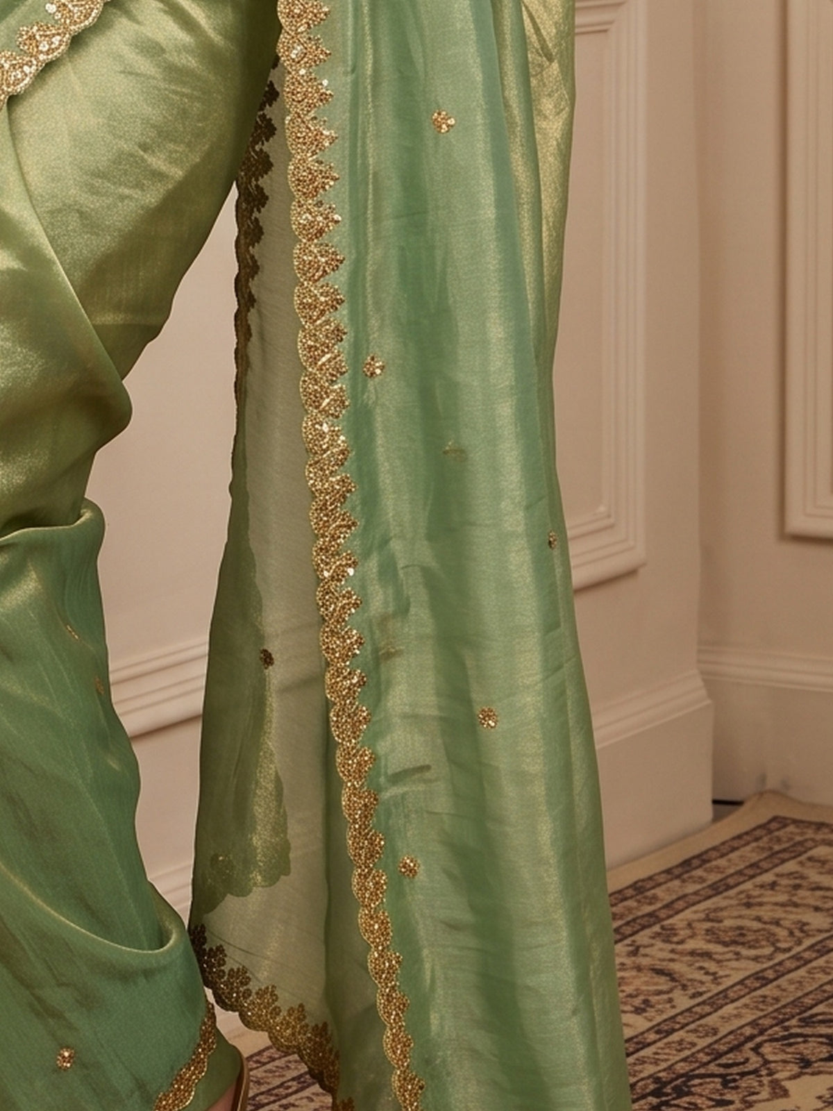 Pallu detail of light green paper silk saree showing embroidered motif work and embroidered border