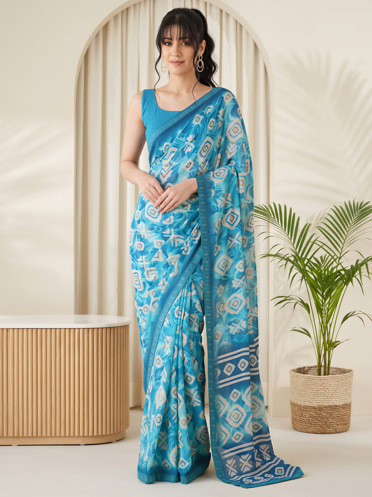 Woman wearing light blue georgette saree with batik wax-resist design and light blue blouse