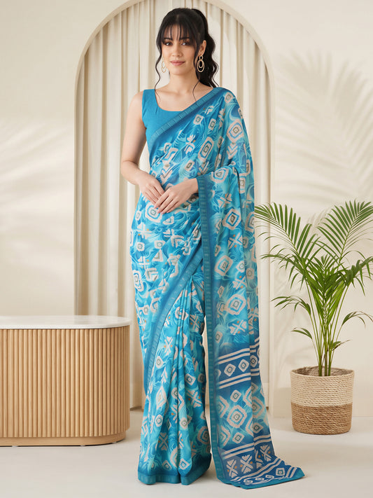 Woman wearing light blue georgette saree with batik wax-resist design and light blue blouse