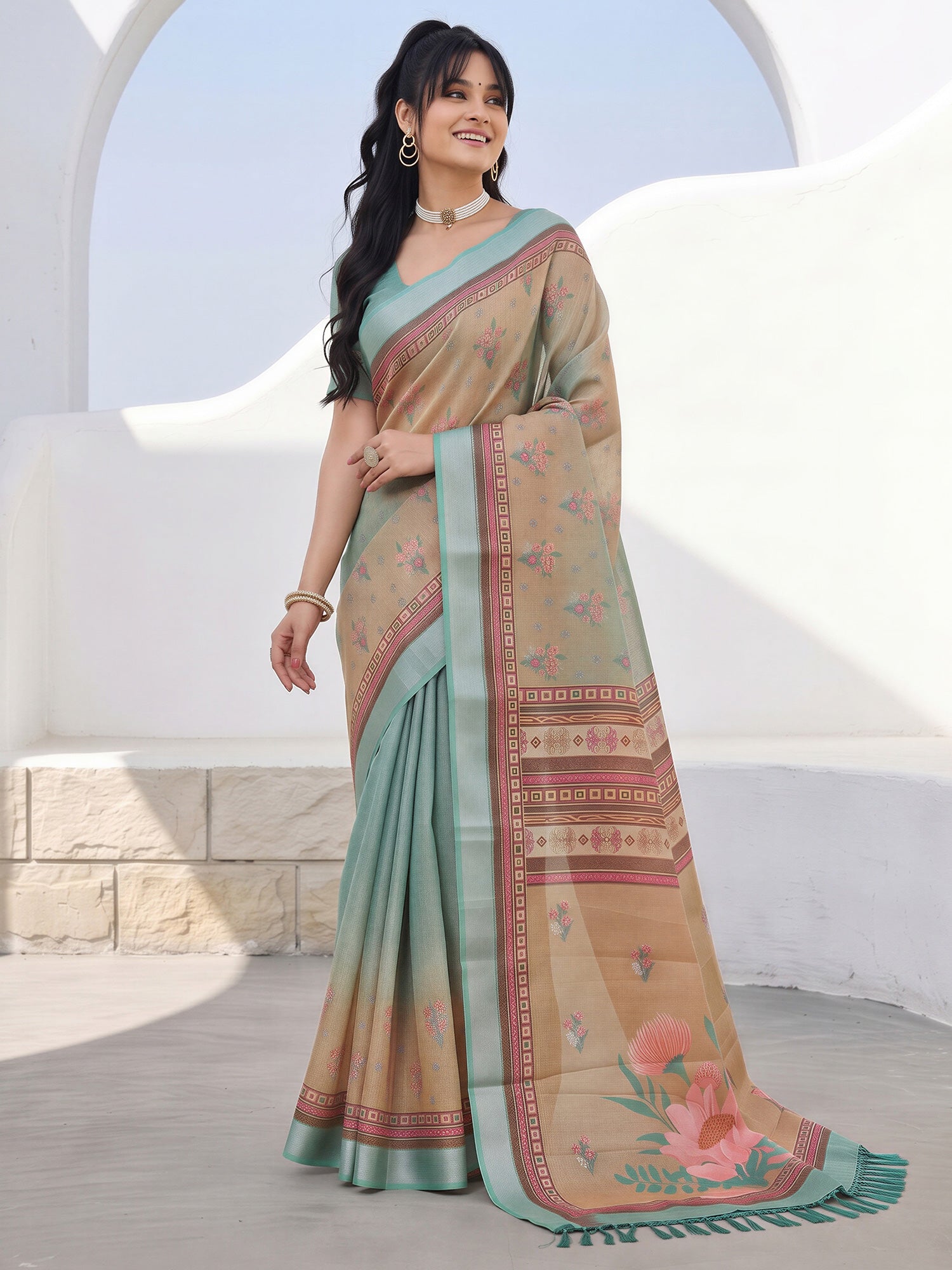 Woman wearing light brown cotton silk saree with botanical floral and leaf design and teal green blouse