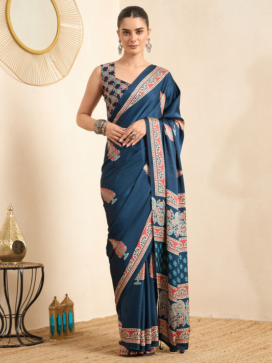 Woman wearing teal blue pure crepe saree with traditional indian motif work and teal blue blouse