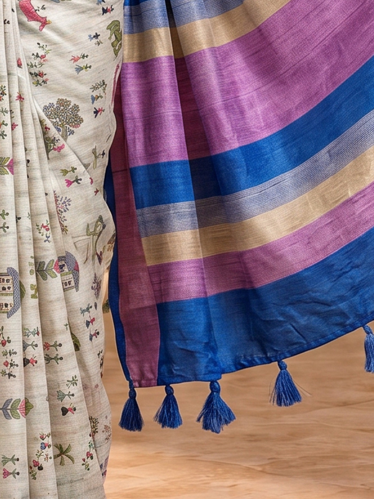 Pallu detail of light blue soft silk saree showing tribal folk-art motifs and printed border