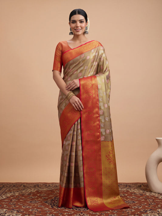 Woman wearing gold banarasi silk saree with traditional indian motif work and orange blouse