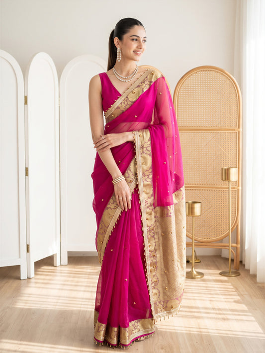 Woman wearing pink silk blend saree with traditional indian motif work and pink blouse
