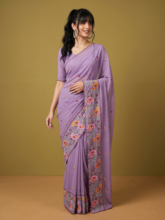 Woman wearing lavender georgette saree with embroidered motif work and lavender blouse
