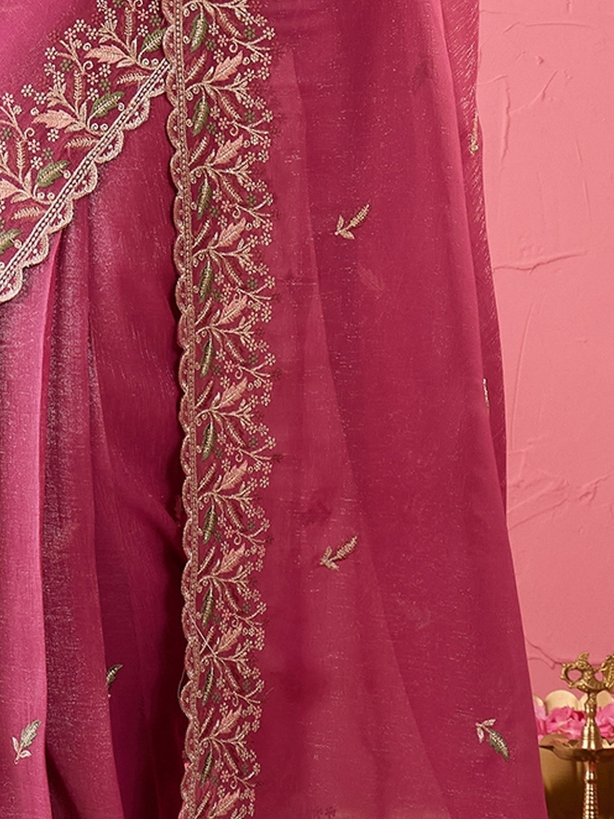 Pallu detail of pink chiffon saree showing embroidered motif work and embroidered border