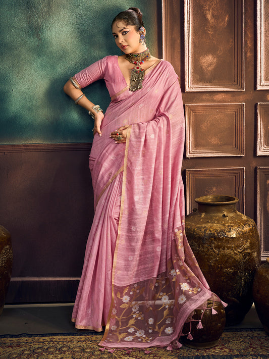 Woman wearing pink muga cotton saree with zari butta (metallic motif) work and pink blouse