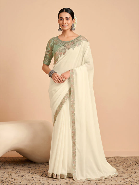 Woman wearing off white tissue saree with embroidered motif work and mint green blouse