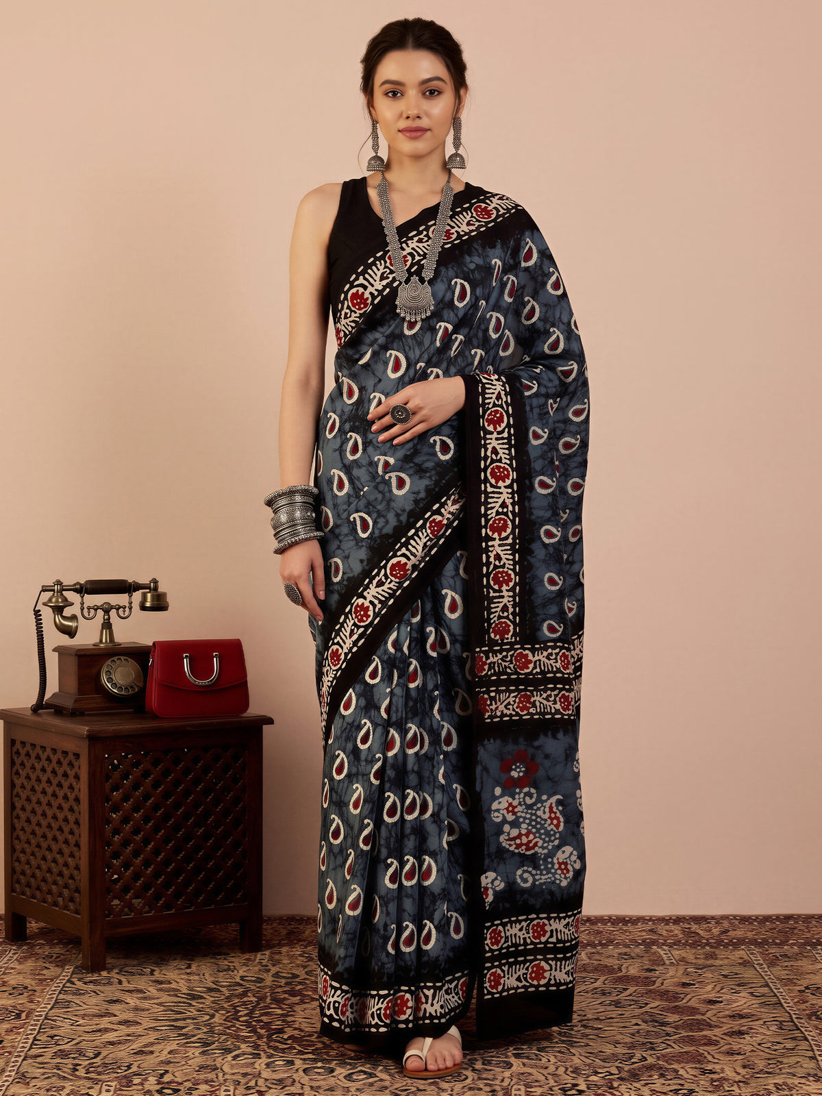 Woman wearing grey bhagalpuri silk saree with shibori resist-dye pattern and black blouse