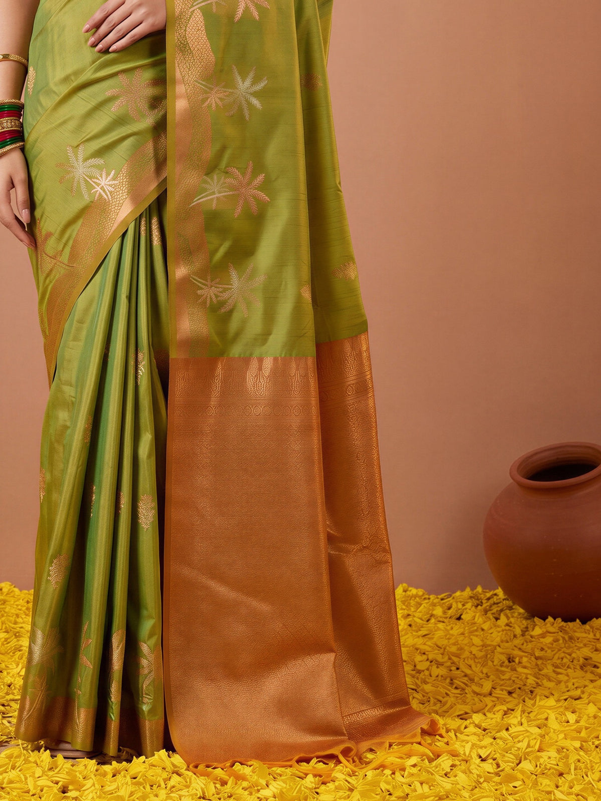 Pallu detail of light green tussar silk saree showing traditional indian motif work and zari border