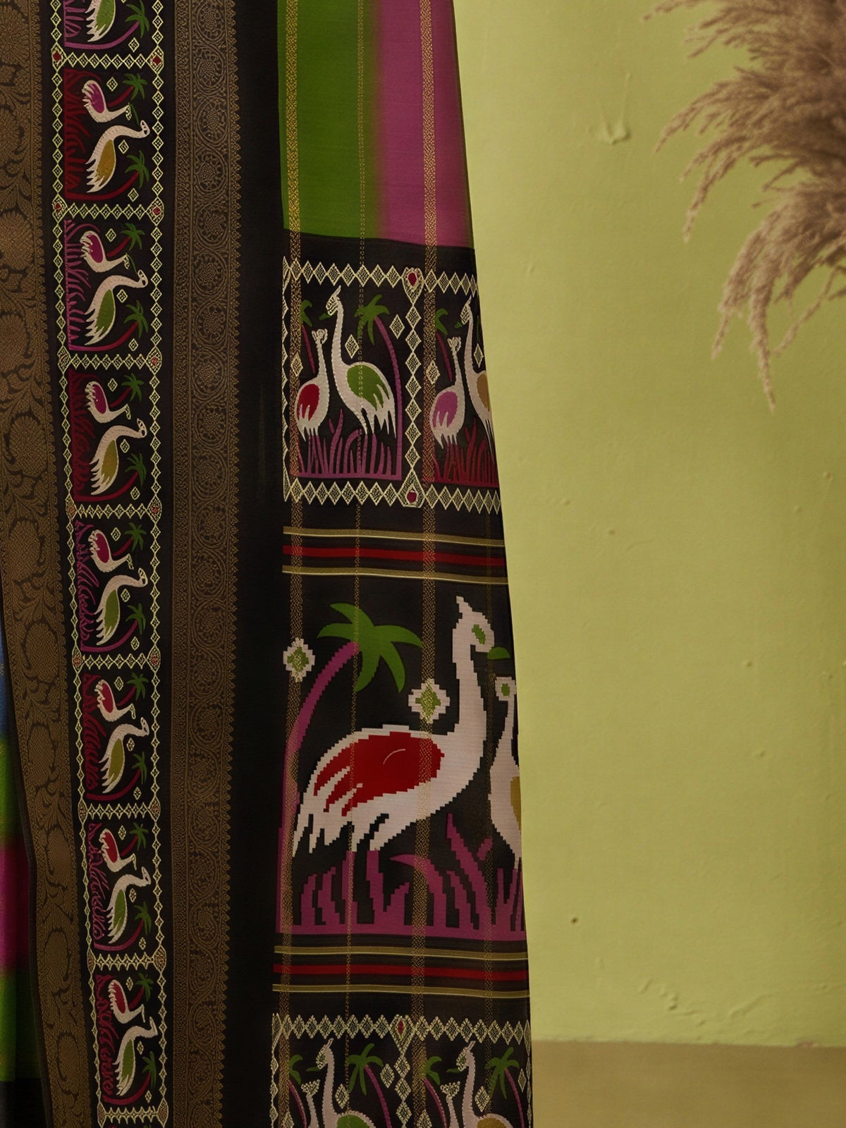 Pallu detail of multicolored dola silk saree showing traditional indian motif work and zari border