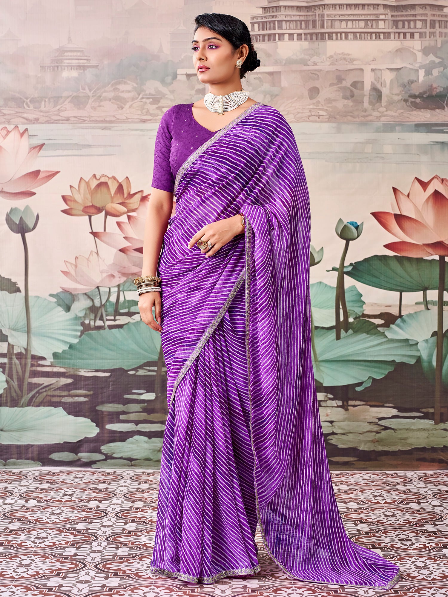 Woman wearing purple georgette saree with striped pattern design and purple blouse
