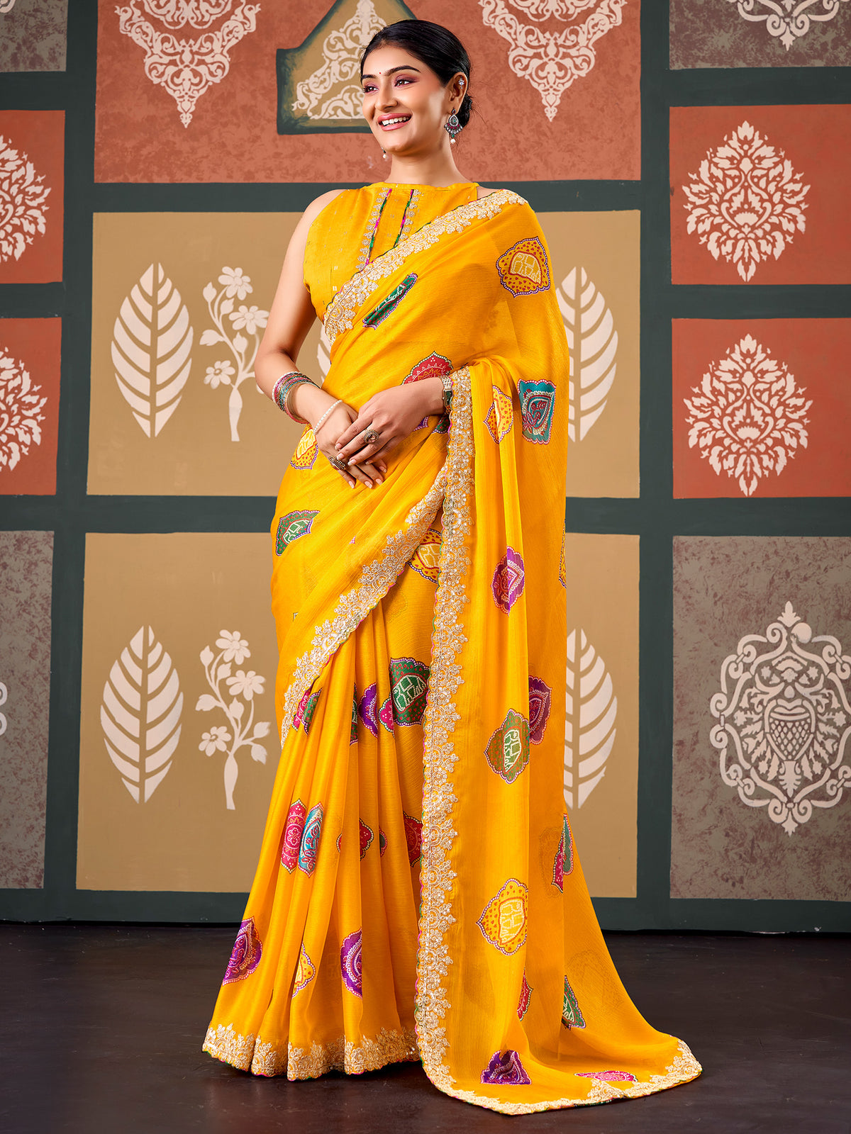 Woman wearing yellow chiffon saree with bandhani tie-dye dot work and yellow blouse