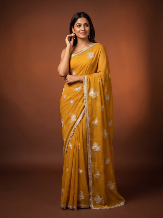 Woman wearing yellow georgette saree with embroidered motif work and yellow blouse