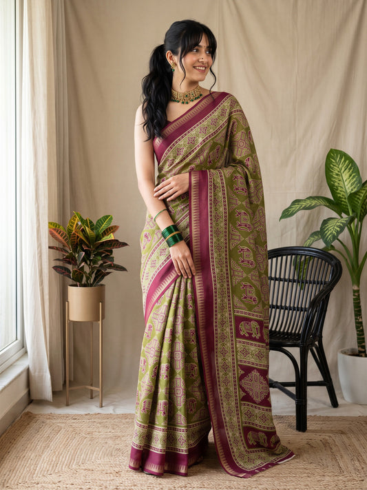 Woman wearing olive georgette saree with traditional indian motif work and wine blouse