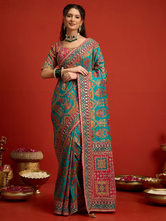 Woman wearing aqua blue silk blend saree with traditional indian motif work and pink blouse