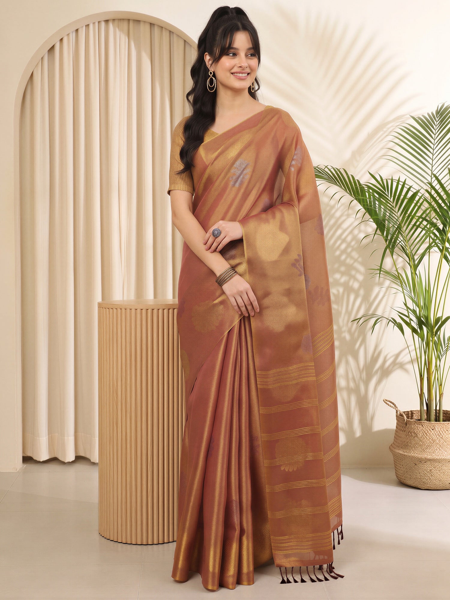 Woman wearing metallic linen saree with traditional indian motif work and metallic blouse