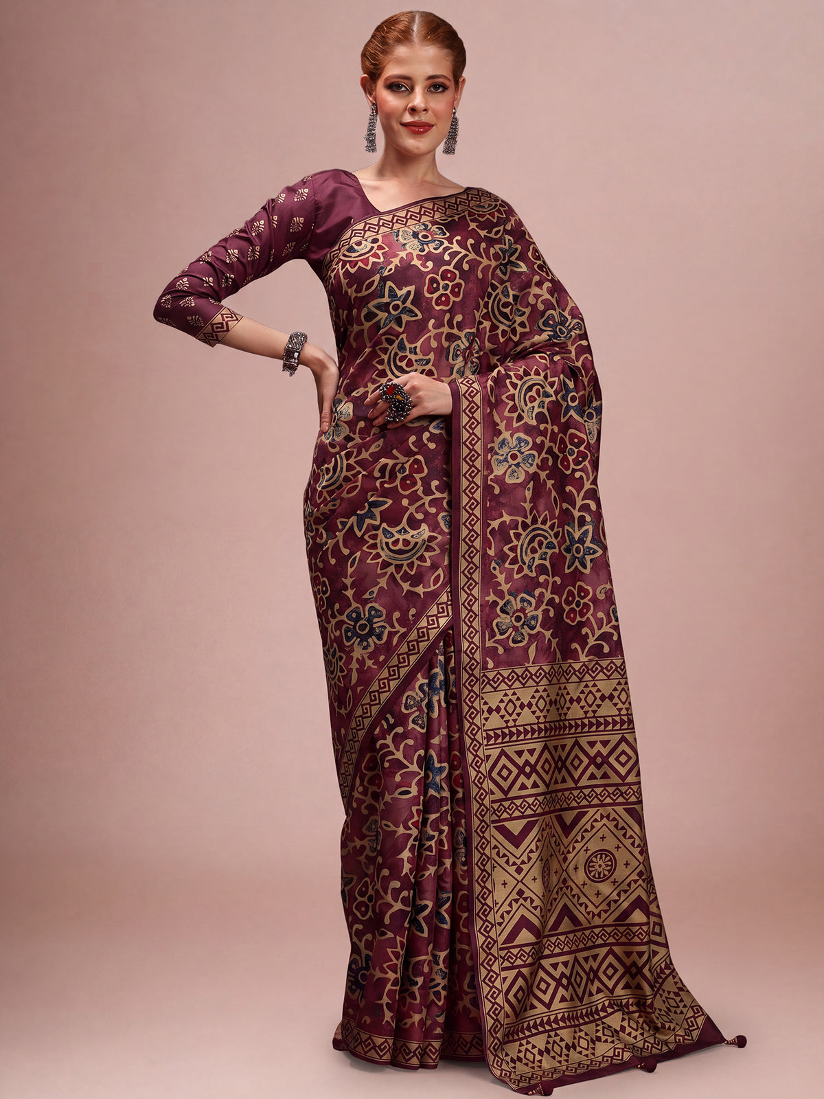 Woman wearing wine silk blend saree with traditional indian motif work and wine blouse
