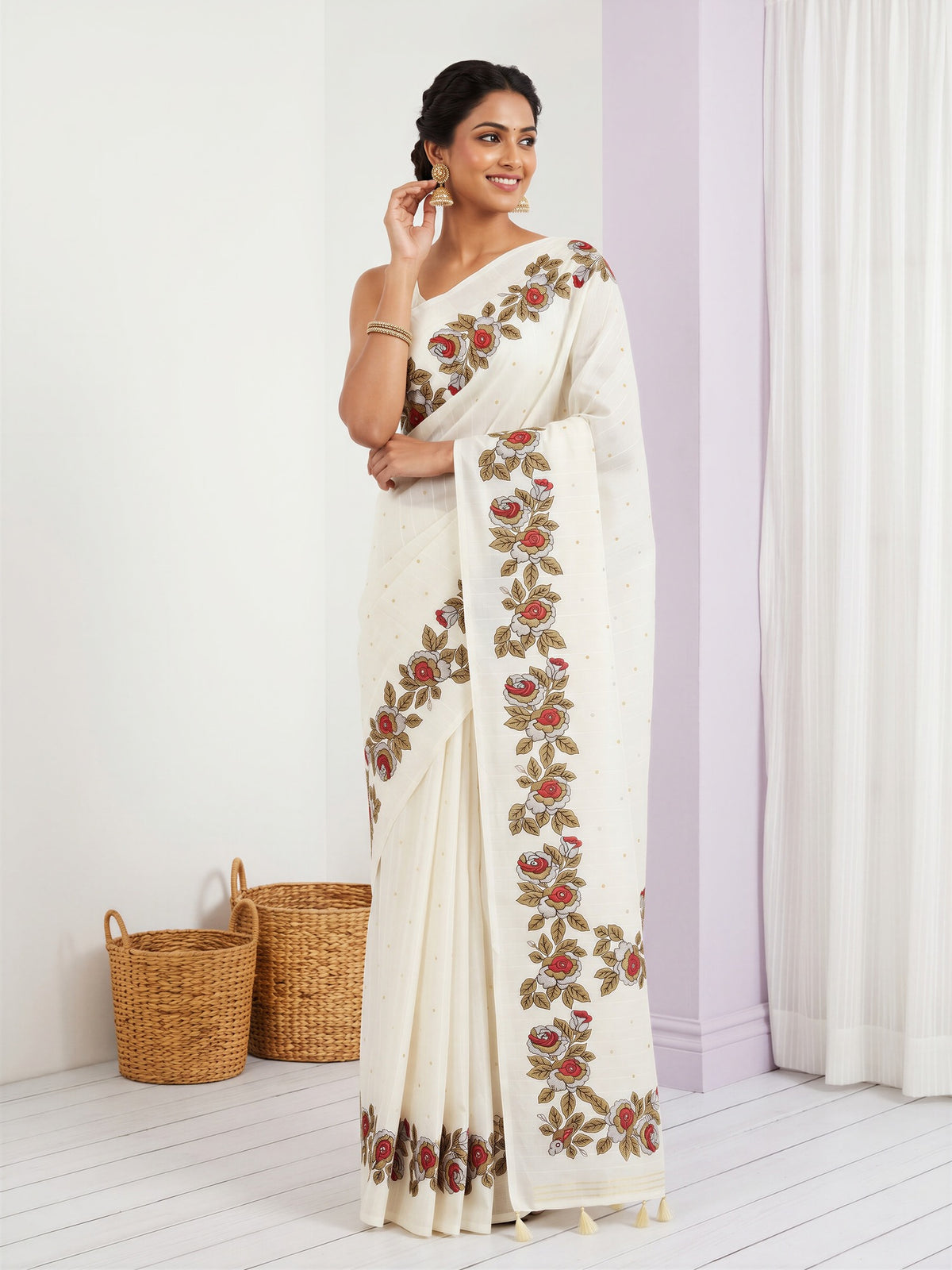 Woman wearing off white dola silk saree with zari butta (metallic motif) work and off white blouse
