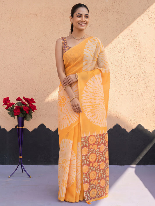Woman wearing mustard cotton blend saree with shibori resist-dye pattern and multicolored blouse