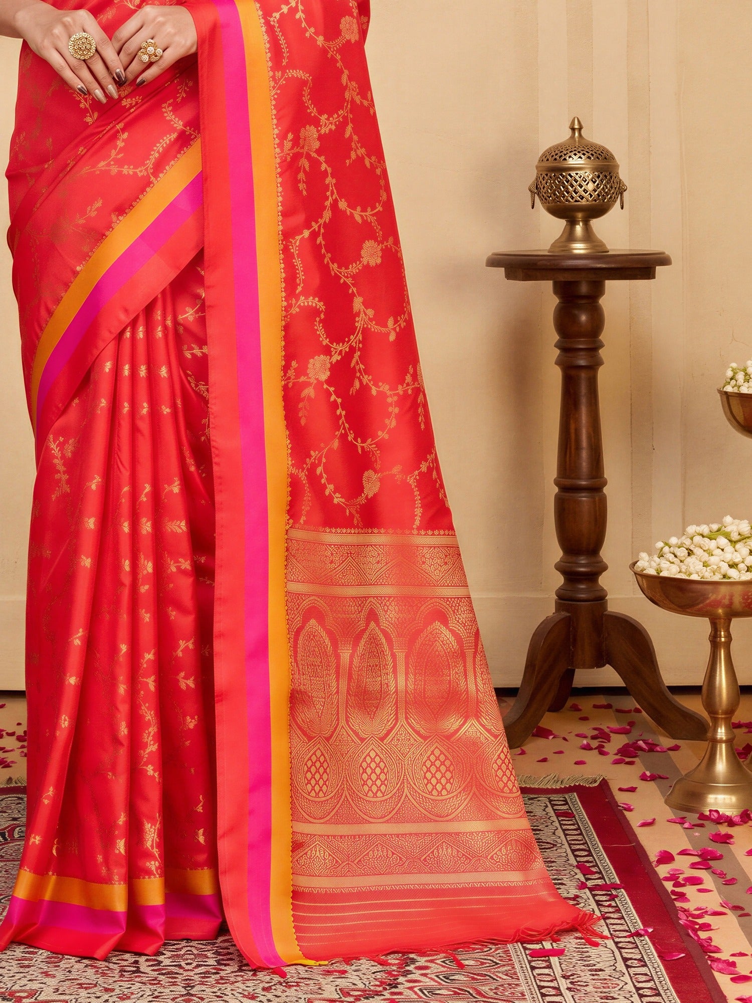 Pallu detail of coral pure silk saree showing traditional indian motif work and zari border