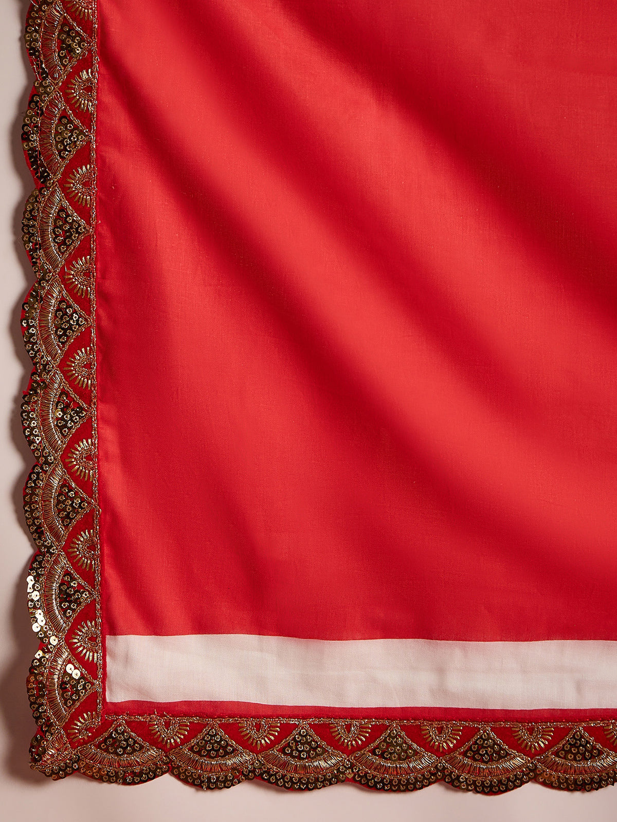 Pallu detail of white cotton saree showing traditional indian motif work and embellished border