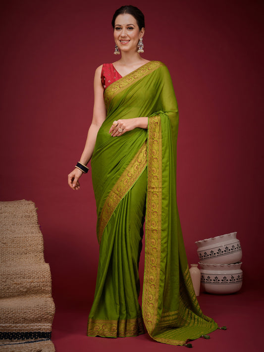 Woman wearing olive mysore silk saree with clean solid-tone finish and red blouse
