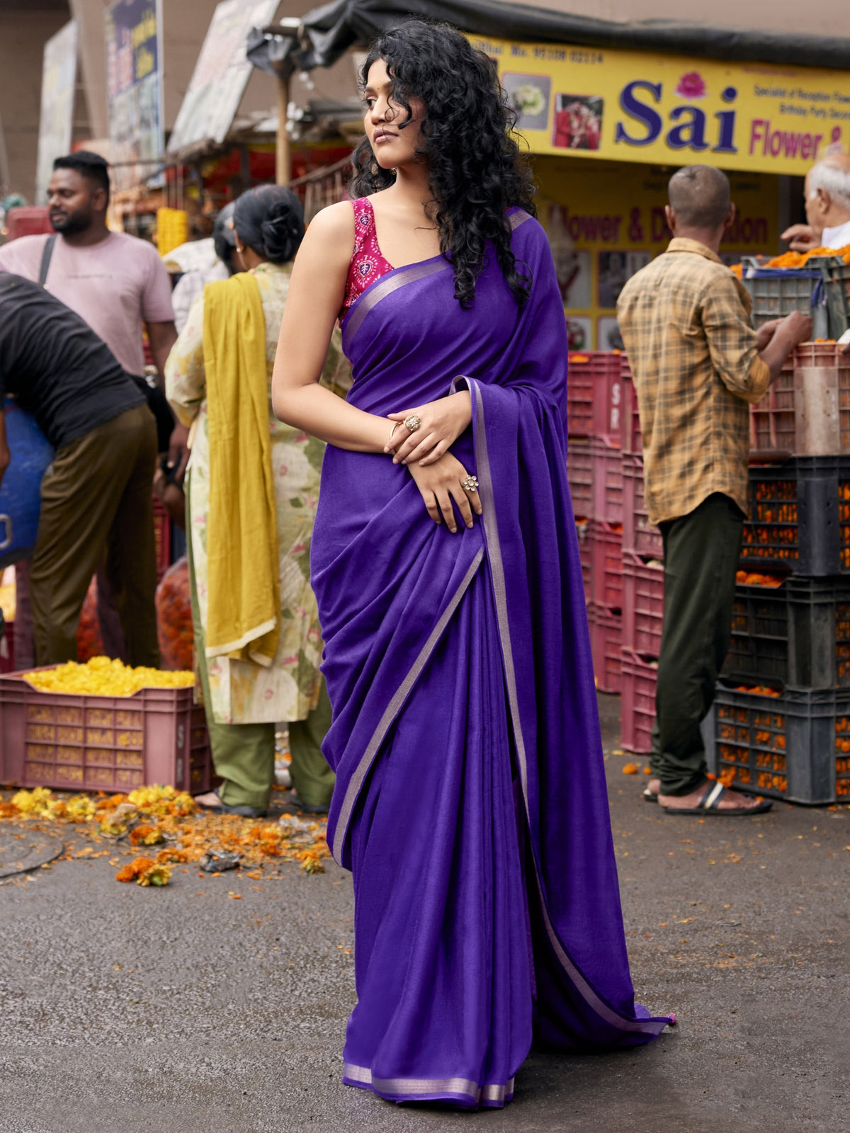 Woman wearing violet cotton blend saree with clean solid-tone finish and pink blouse
